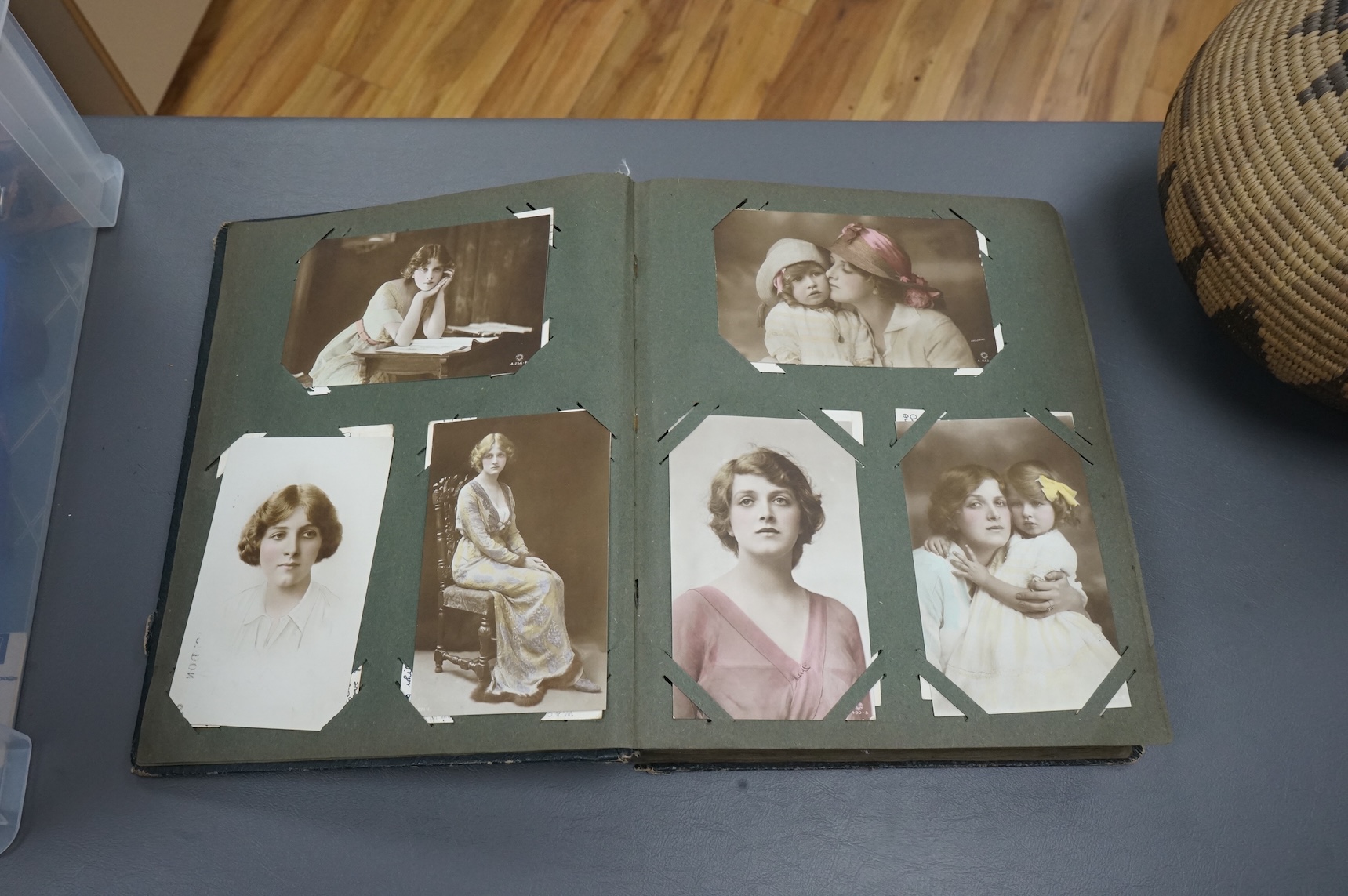 A postcard album containing early 20th century postcards, Gladys Cooper, comics, some photographs